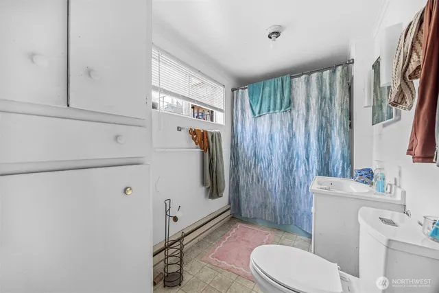 a white toilet sitting next to a bathroom sink