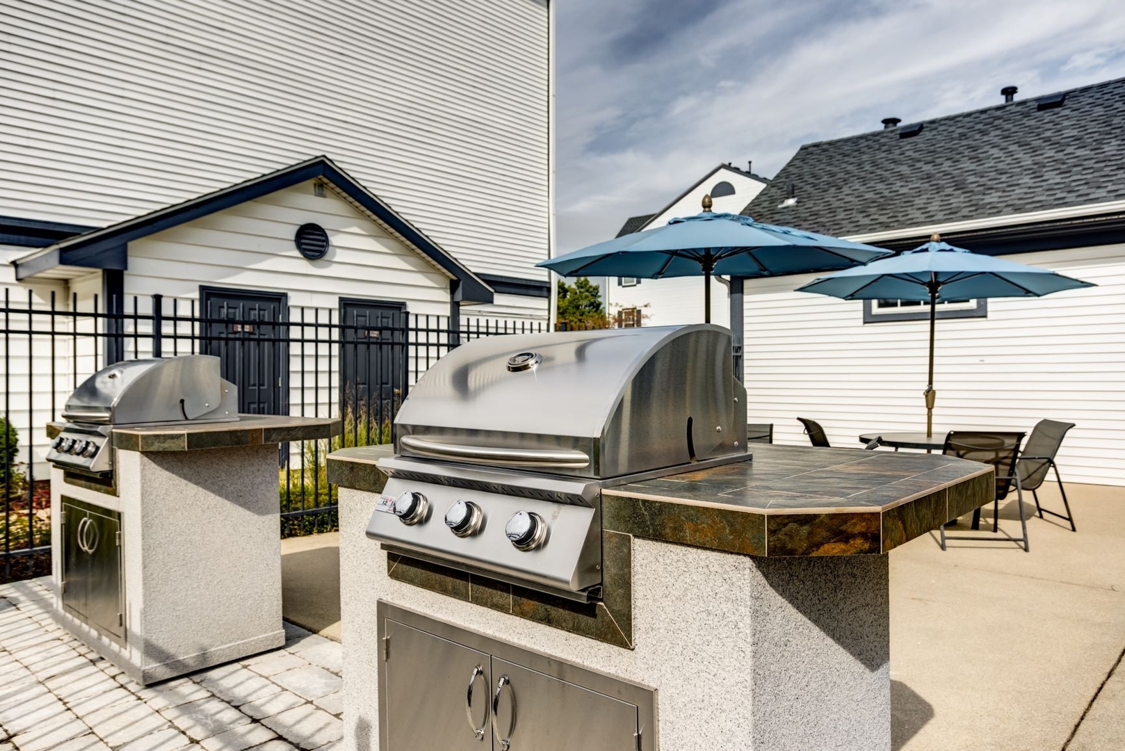 112 Gershwin Court, Unit 112 Wheaton, IL 60189 - Photo 18 of 60 a view of a patio with table and chairs under an umbrella