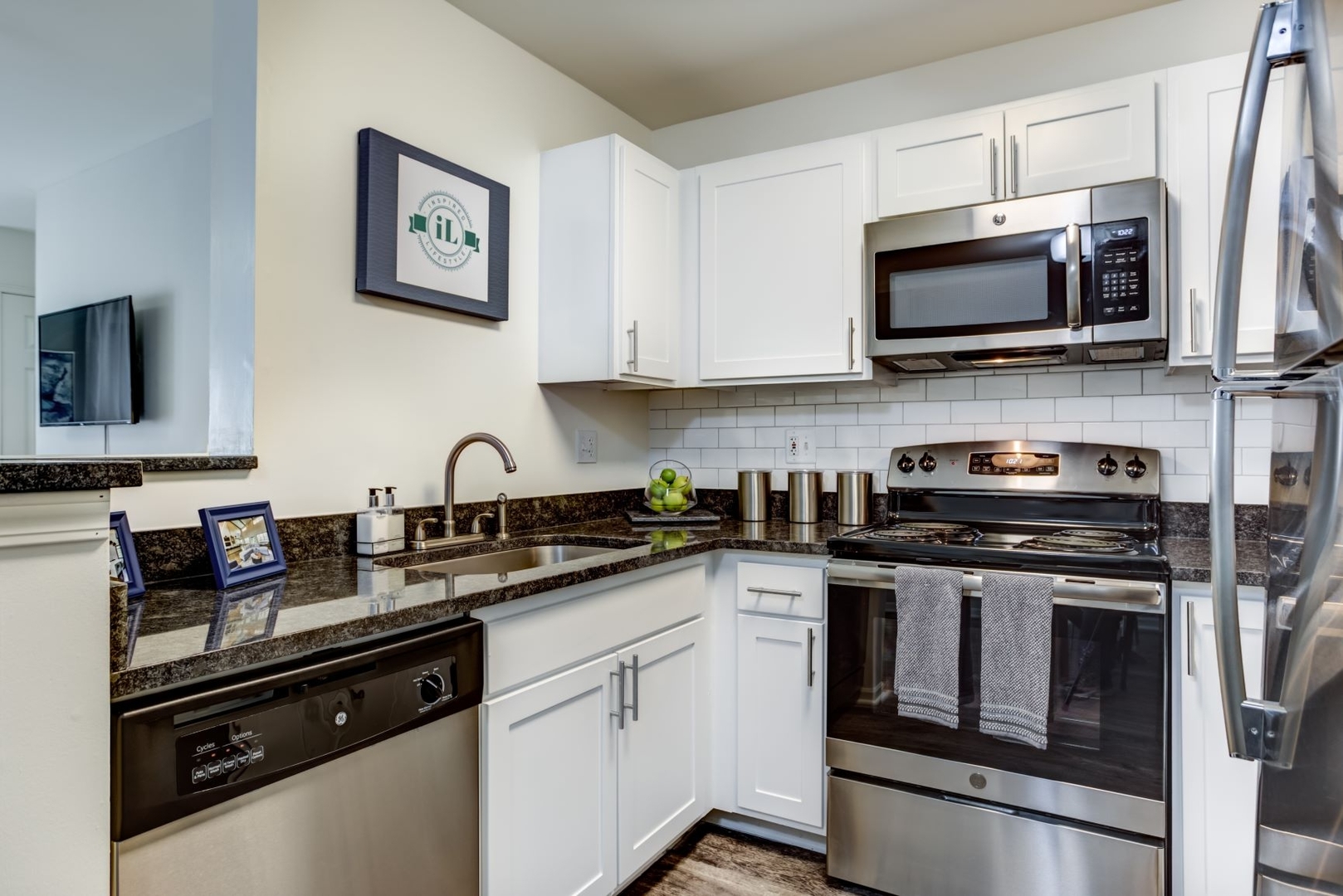 112 Gershwin Court, Unit 112 Wheaton, IL 60189 - Photo 31 of 60 a kitchen with stainless steel appliances granite countertop a sink stove a microwave and cabinets