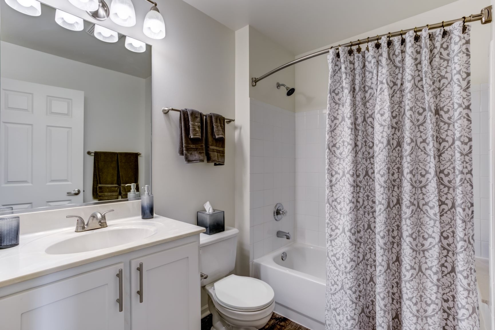 112 Gershwin Court, Unit 112 Wheaton, IL 60189 - Photo 34 of 60 a bathroom with a sink a toilet a mirror a vanity and shower