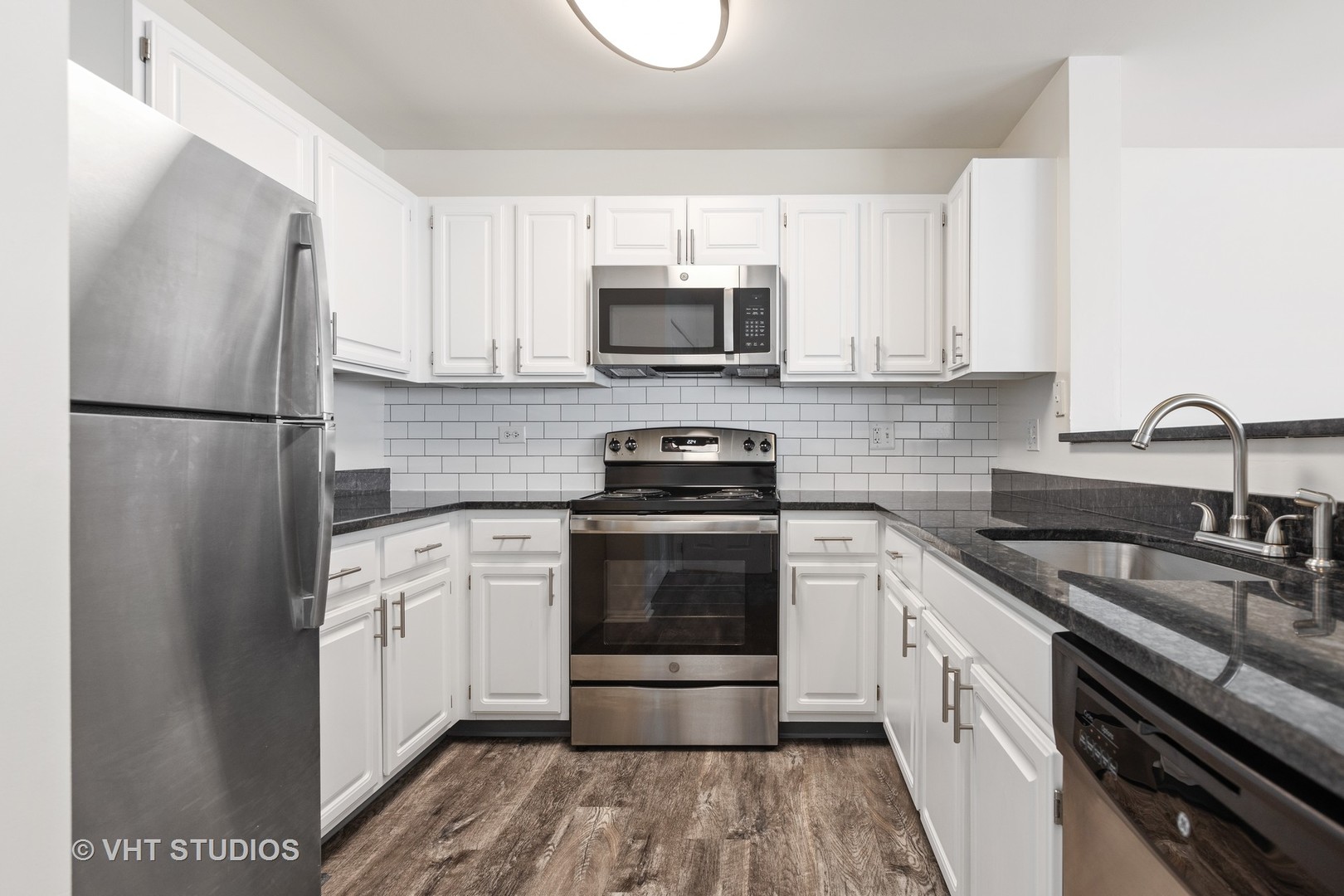 112 Gershwin Court, Unit 112 Wheaton, IL 60189 - Photo 51 of 60 a kitchen with a refrigerator sink and white cabinets