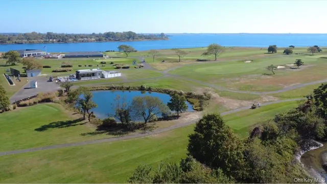 an aerial view of beach and residential houses with outdoor space