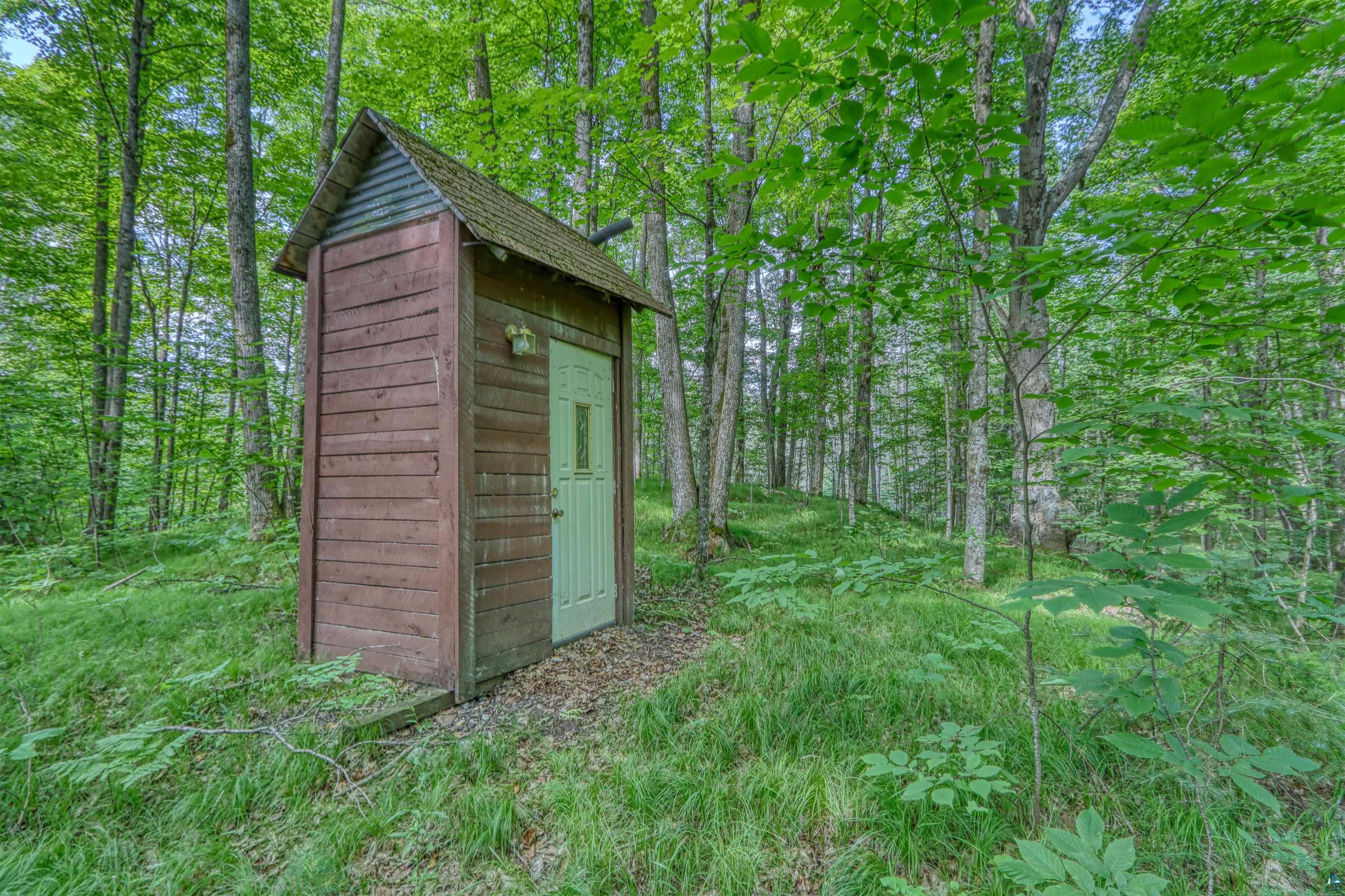 6676 Golf Course Road Winter, WI 54896 - Photo 11 of 51 View of shed with a wooded view