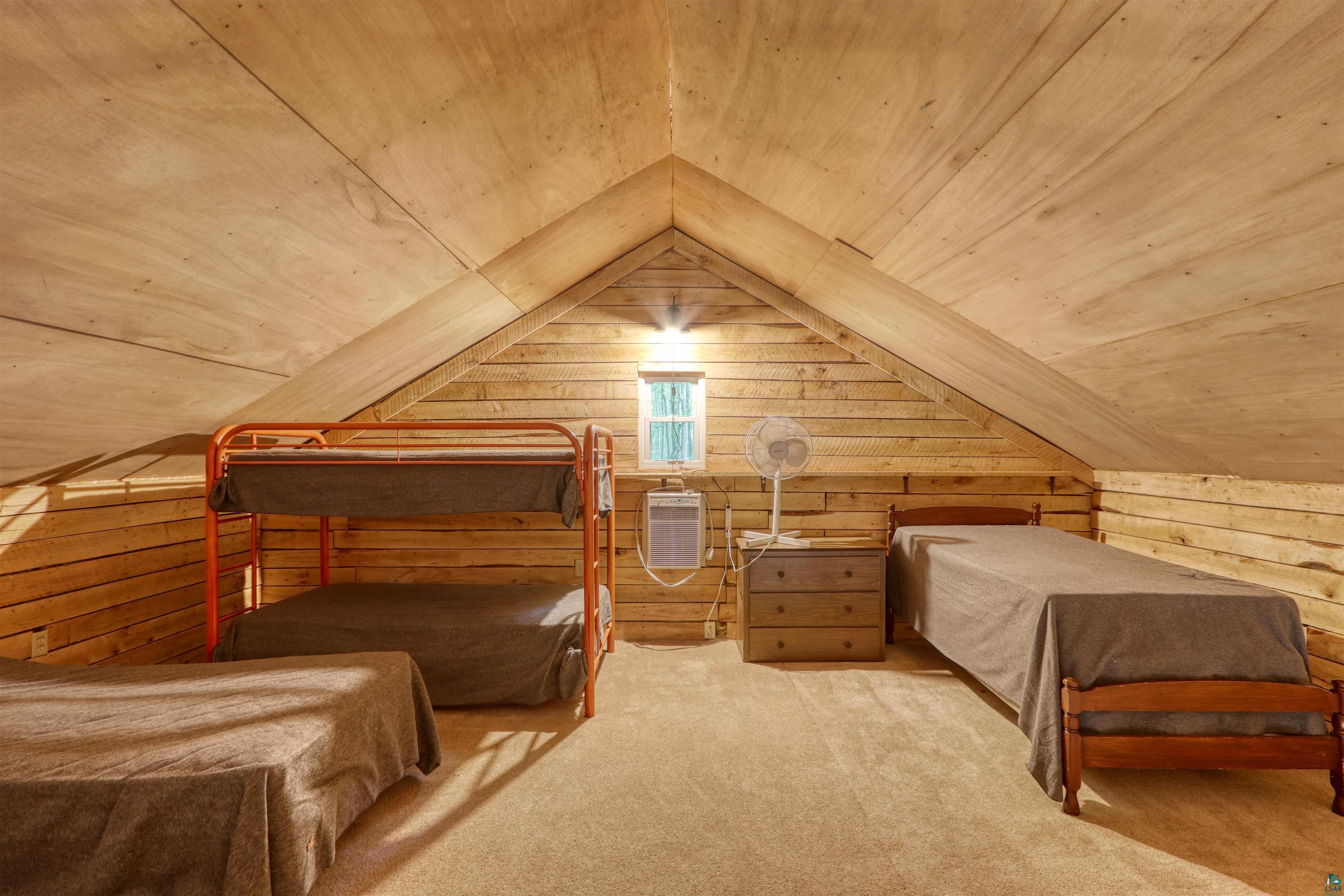6676 Golf Course Road Winter, WI 54896 - Photo 33 of 51 Bedroom featuring wooden walls, wood ceiling, lofted ceiling, and carpet