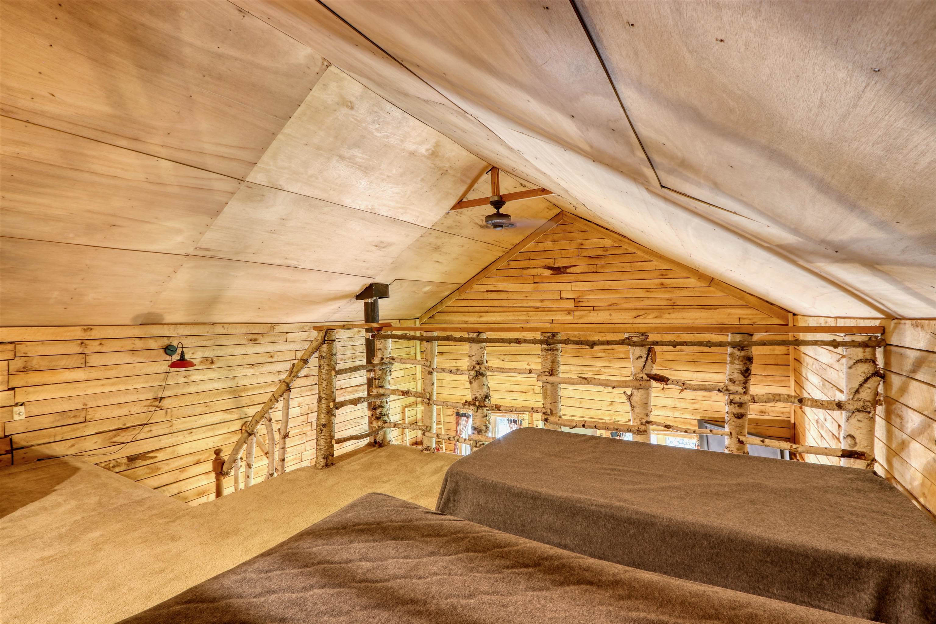 6676 Golf Course Road Winter, WI 54896 - Photo 34 of 51 Bedroom with wood walls, lofted ceiling, and carpet floors