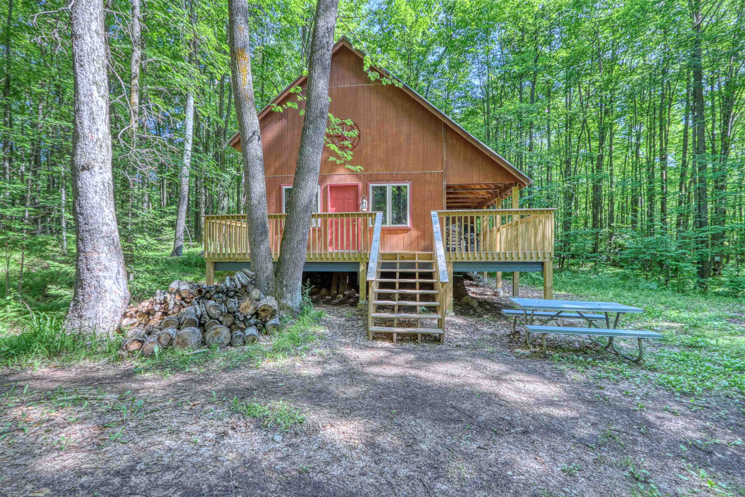 6676 Golf Course Road Winter, WI 54896 - Photo 38 of 51 Rustic home featuring a deck, a wooded view, and stairs