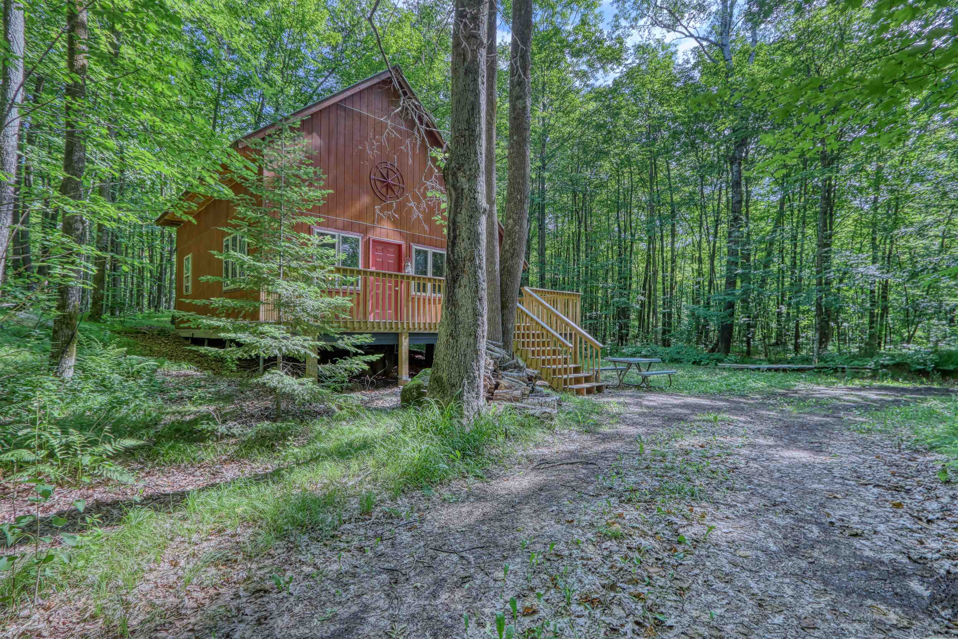 6676 Golf Course Road Winter, WI 54896 - Photo 41 of 51 View of front of house with a wooden deck, stairs, and a wooded view
