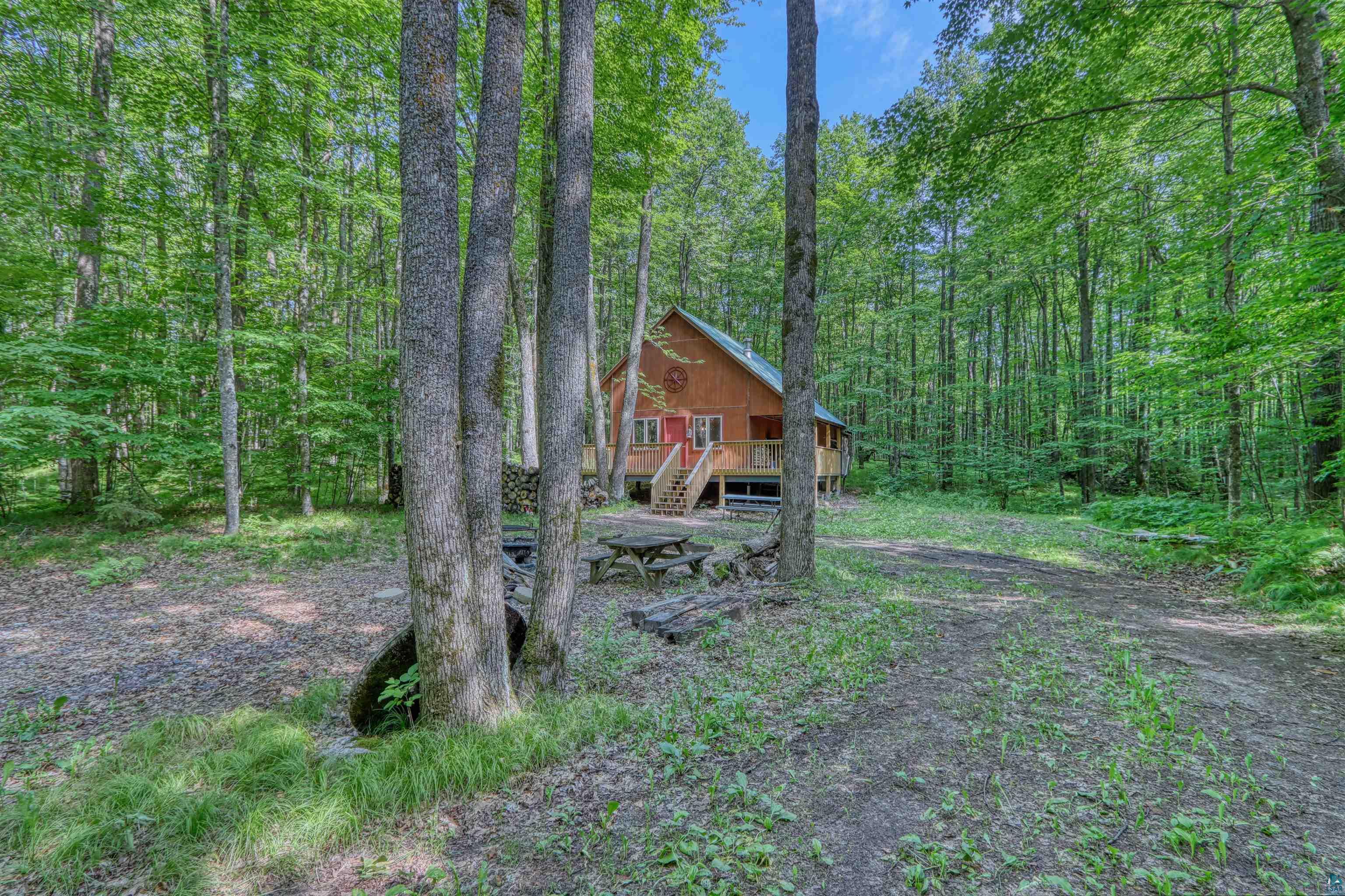 6676 Golf Course Road Winter, WI 54896 - Photo 45 of 51 View of front of house with stairway, a wooded view, and a wooden deck