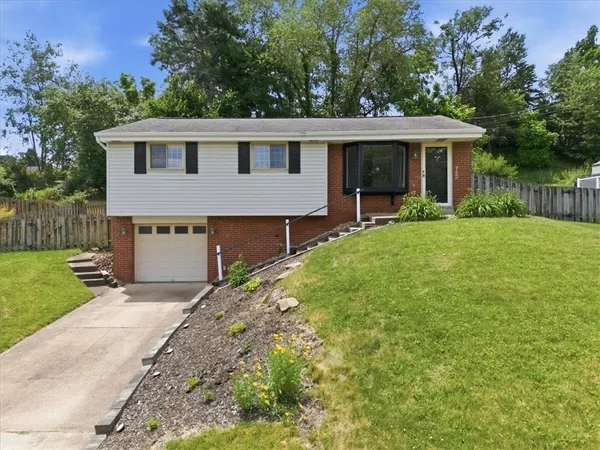 a front view of house with yard and green space