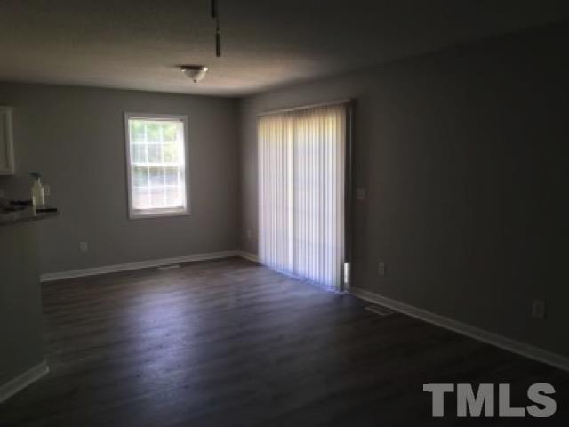 2717 Denbel Circle Raleigh, NC 27604 - Photo 3 of 16 an empty room with wooden floor and windows