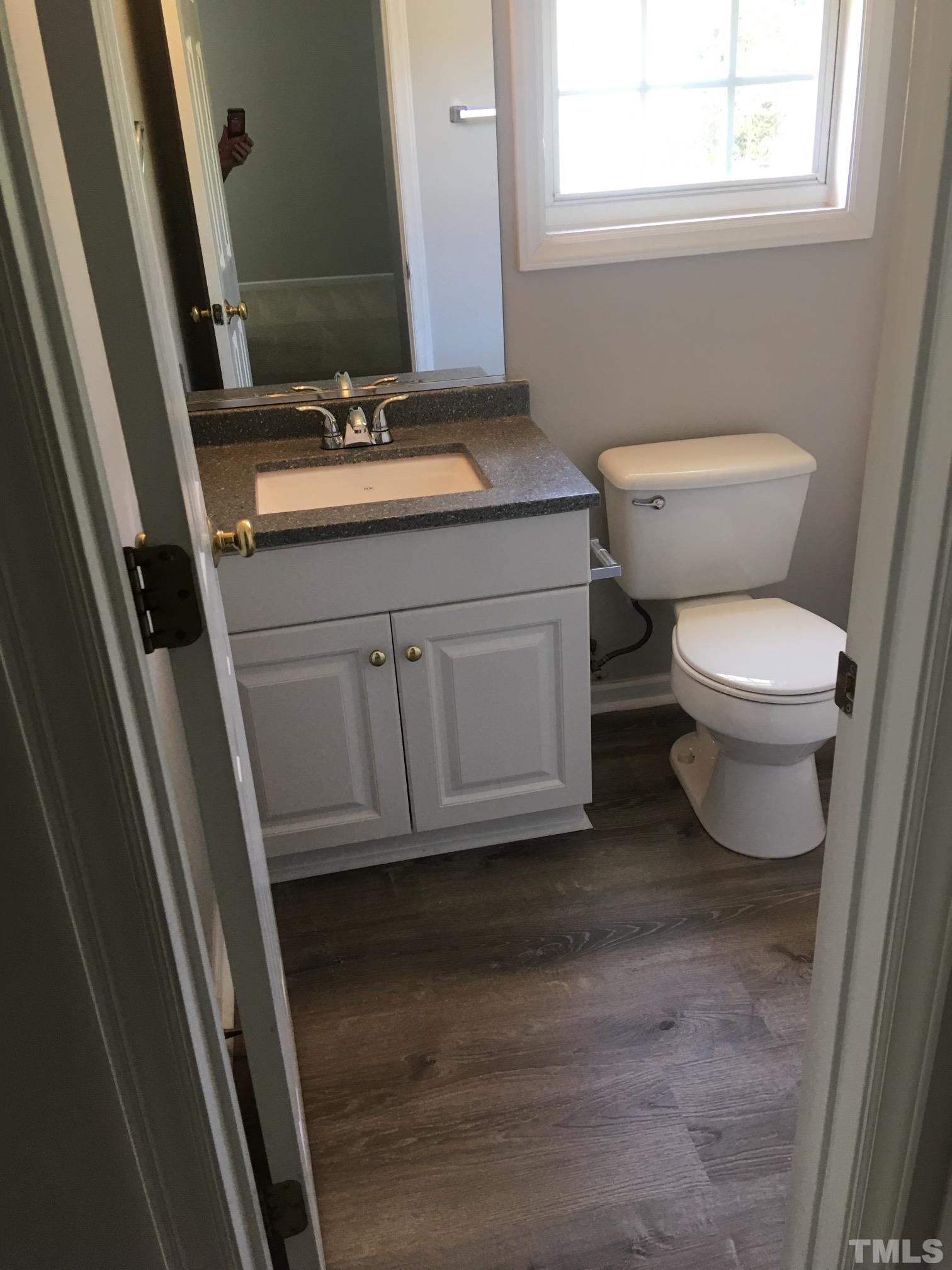 2717 Denbel Circle Raleigh, NC 27604 - Photo 10 of 16 a bathroom with a granite countertop toilet sink and mirror
