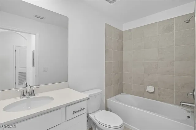 a bathroom with a sink a toilet and bathtub