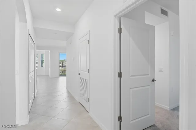 a view of a hallway with a wooden cabinets