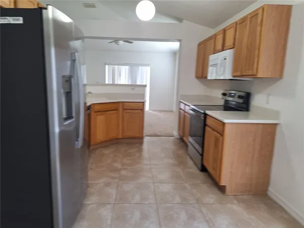 a view of a kitchen with electric appliances