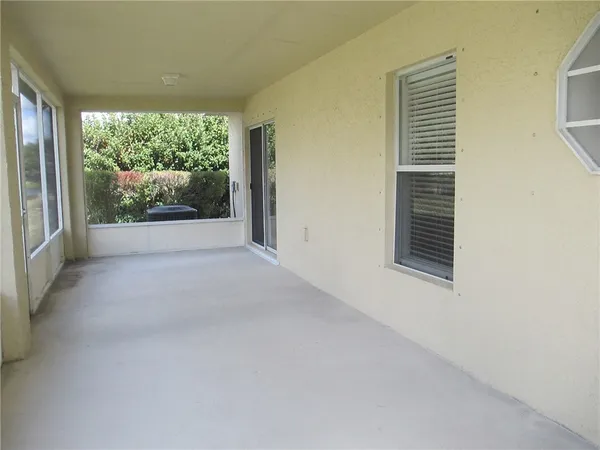 a view of an empty room with windows
