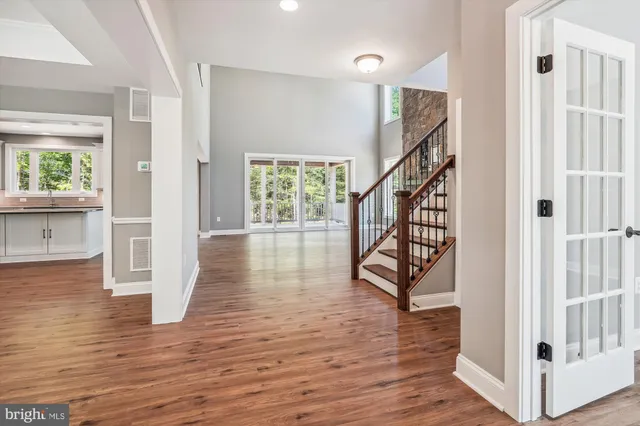 a view of empty room with fireplace and wooden floor