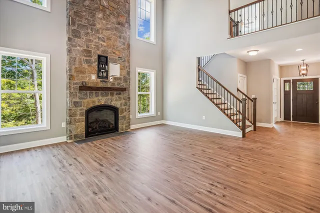 a view of a livingroom with wooden floor and stairs