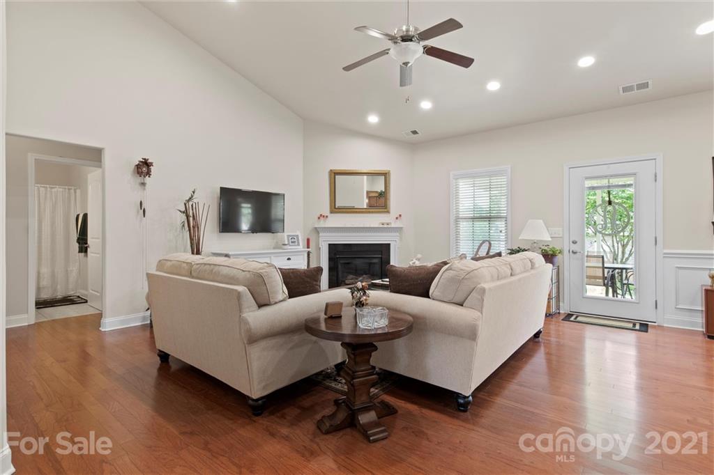 7266 Kenyon Drive Denver, NC 28037 - Photo 3 of 13 a living room with fireplace furniture and a wooden floor
