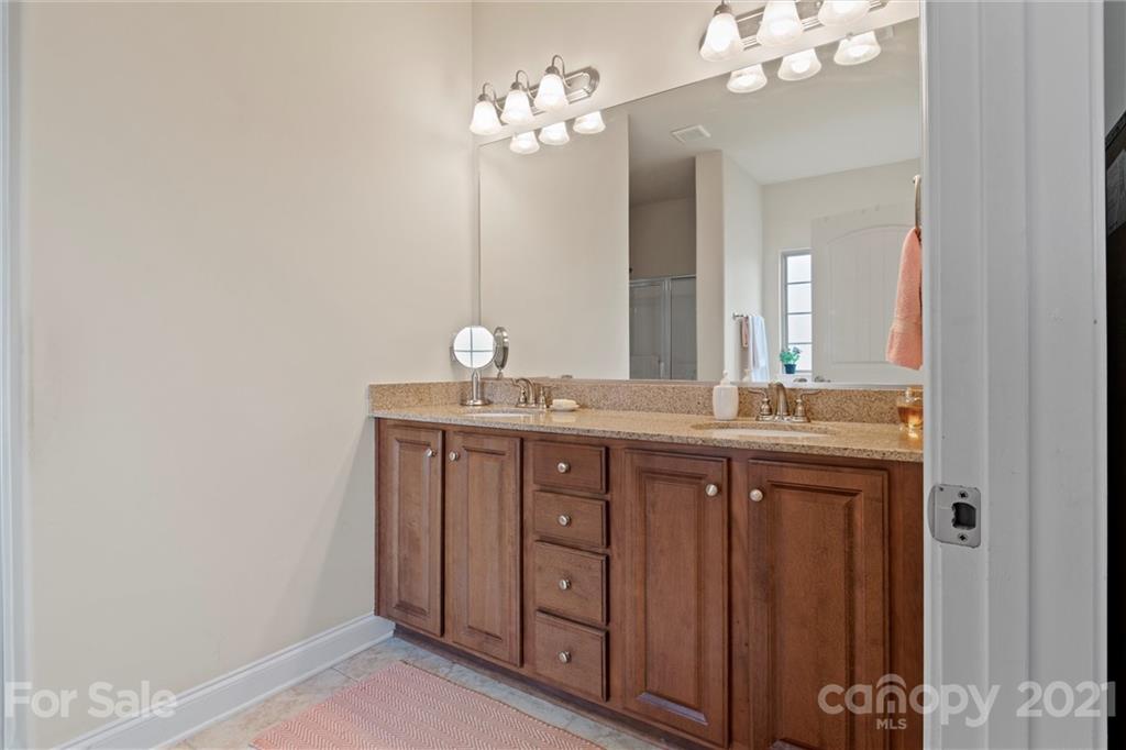 7266 Kenyon Drive Denver, NC 28037 - Photo 7 of 13 a bathroom with a double vanity and a mirror
