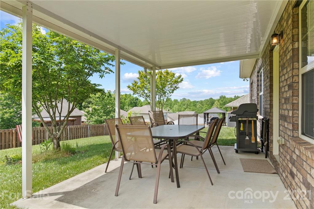 7266 Kenyon Drive Denver, NC 28037 - Photo 10 of 13 a view of an outdoor dining space with a table and chairs