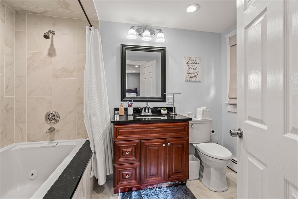 13 Sunnyvale Street Beverly, MA 01915 - Photo 17 of 18 a bathroom with a toilet a sink and bathtub