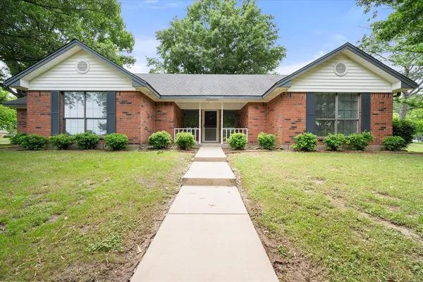 a front view of a house with yard
