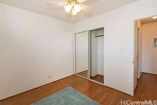 an empty room with wooden floor and window