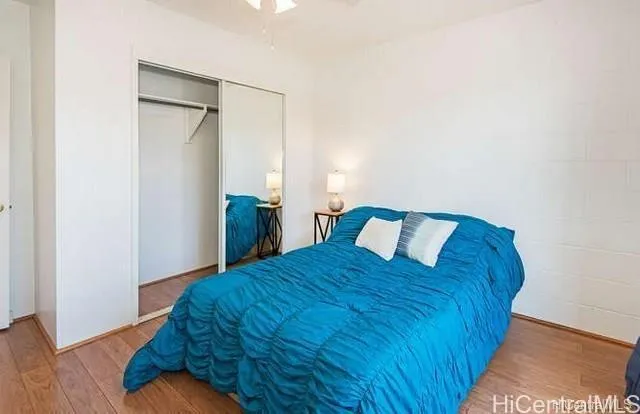 a bed sitting in a bedroom and wooden floor