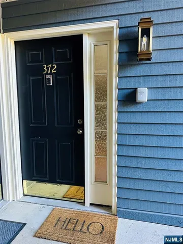 a view of a room with wooden floor and a window
