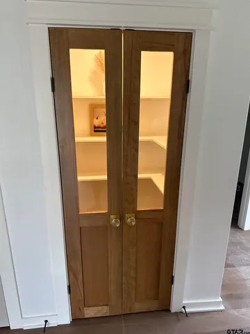 a view of walk in closet with empty tub