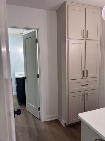 a view of an empty room with a mirror