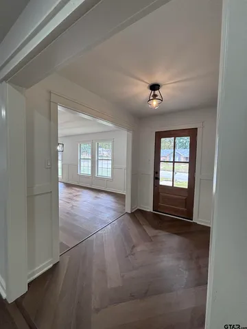 an empty room with windows and cabinet