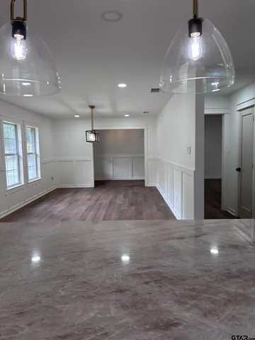 an empty room with a space and windows