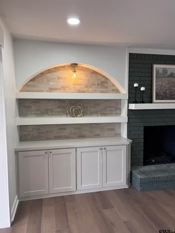 a living room with a fireplace and a fireplace