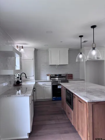 a kitchen with a stove and a window