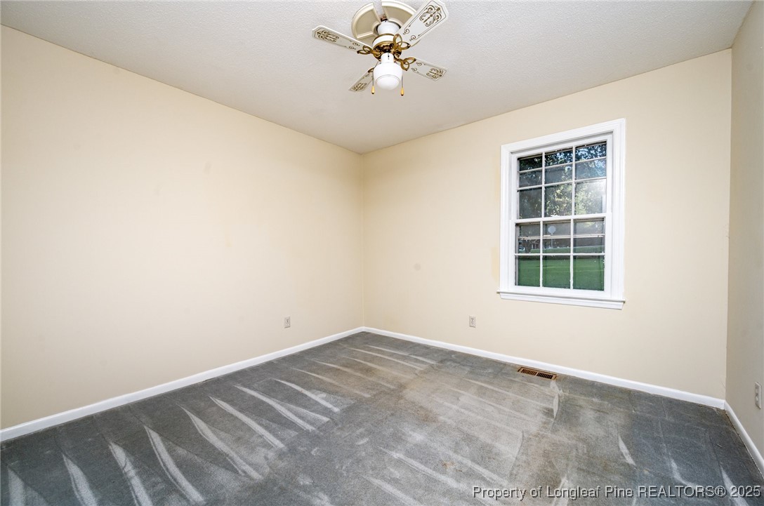2470 Hickory House Road Sanford, NC 27332 - Photo 15 of 27 an empty room with a window and a fan