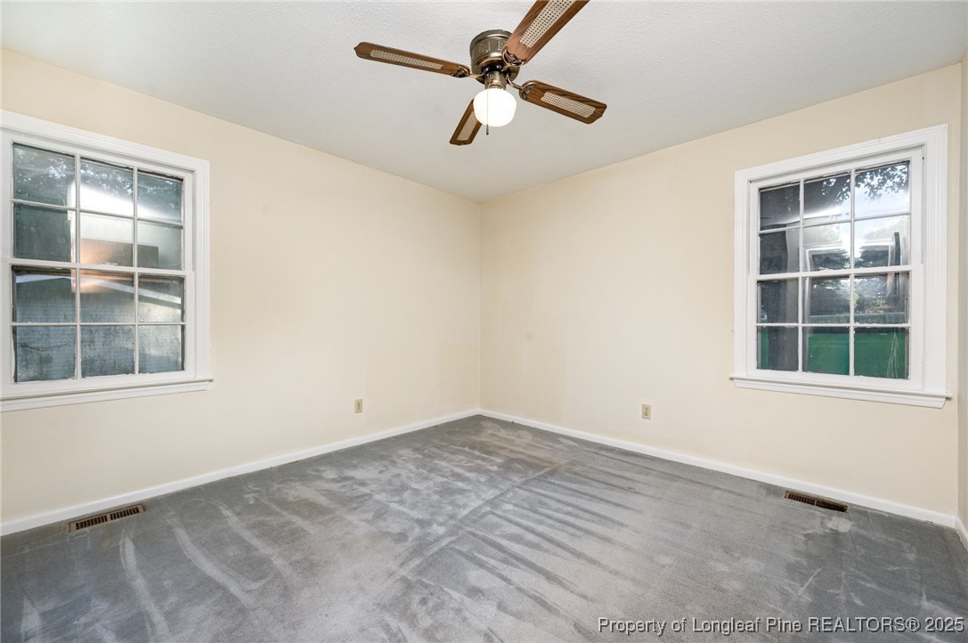 2470 Hickory House Road Sanford, NC 27332 - Photo 17 of 27 an empty room with windows and fan