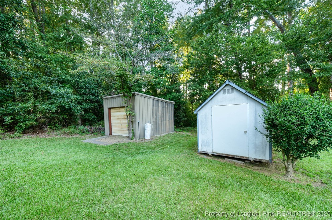 2470 Hickory House Road Sanford, NC 27332 - Photo 22 of 27 a view of a house with backyard and garden