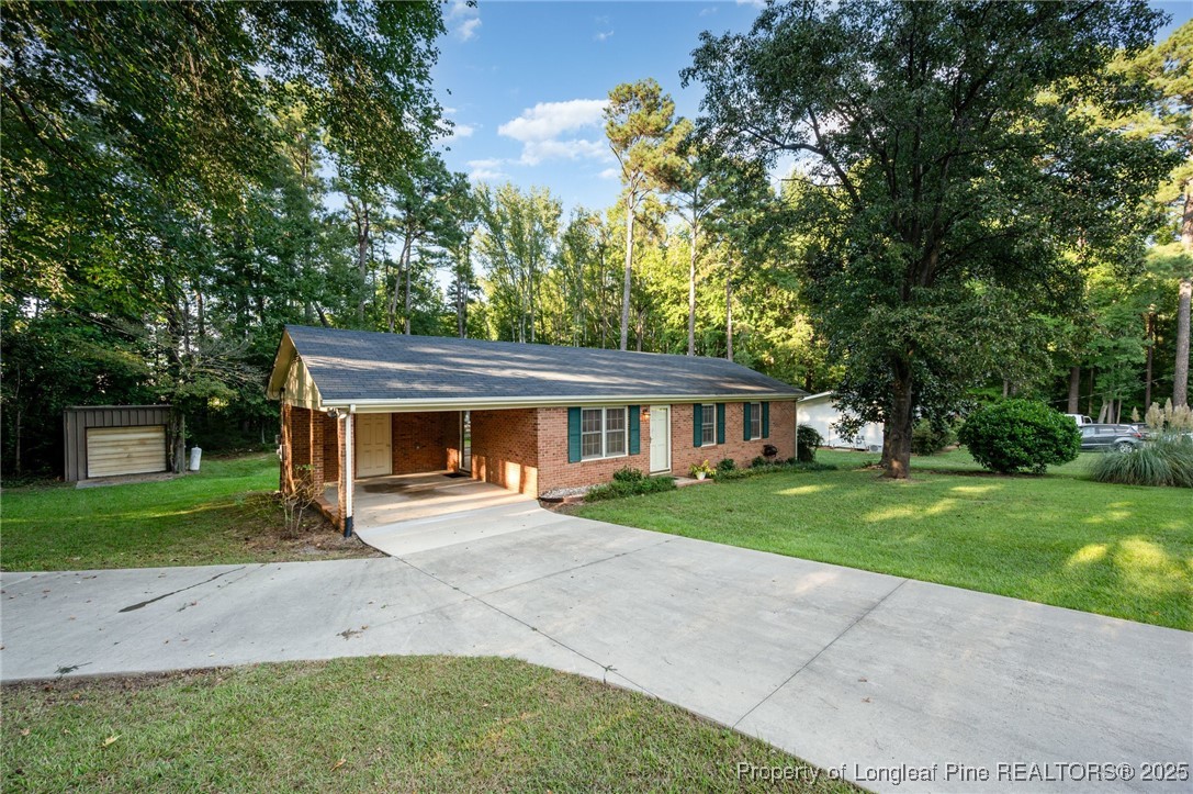 2470 Hickory House Road Sanford, NC 27332 - Photo 25 of 27 front view of a house with a yard