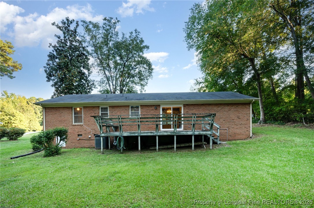 2470 Hickory House Road Sanford, NC 27332 - Photo 26 of 27 front view of a house with a yard and potted plants