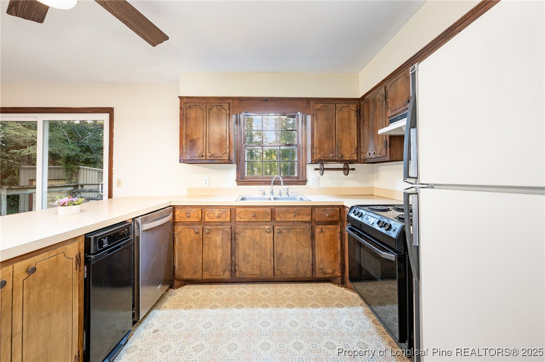 2470 Hickory House Road Sanford, NC 27332 - Photo 7 of 27 a kitchen with stainless steel appliances granite countertop a sink stove and refrigerator