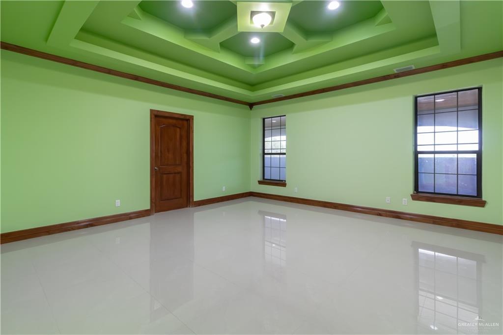 2204 East Trenton Road Edinburg, TX 78542 - Photo 20 of 37 a view of an empty room with window and chandelier fan