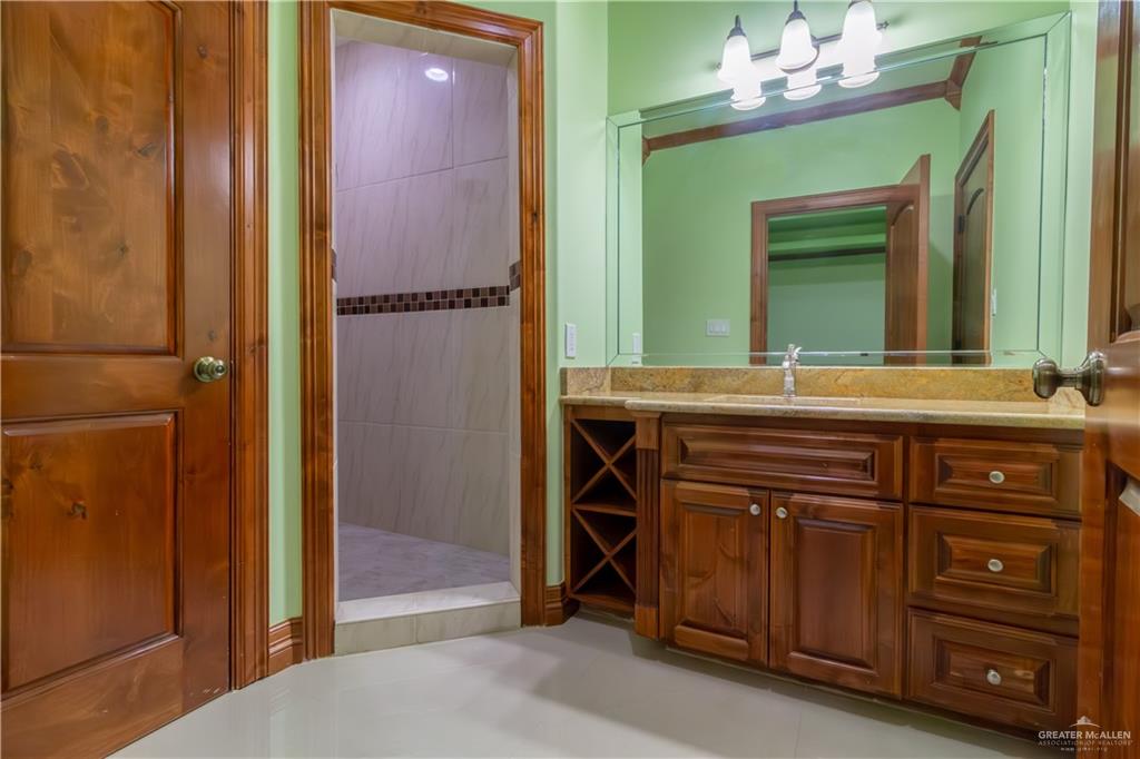 2204 East Trenton Road Edinburg, TX 78542 - Photo 22 of 37 a bathroom with a sink and a mirror