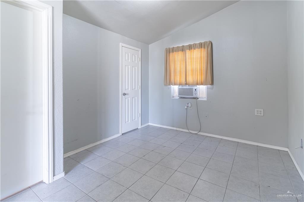 2204 East Trenton Road Edinburg, TX 78542 - Photo 34 of 37 a view of an empty room with window and wooden floor