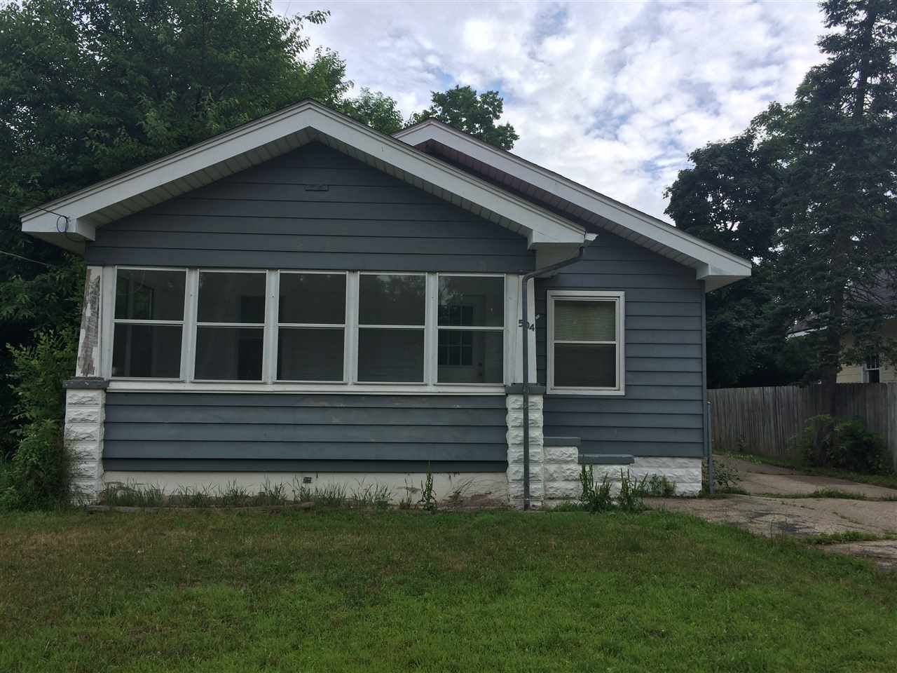504 Brooke Road Rockford, IL 61109 - Photo 1 of 7 a front view of a house with a garden