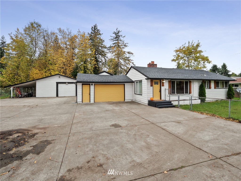 10222 Golden Given Road East Tacoma, WA 98445 - Photo 1 of 23 a front view of a house with a yard and trees