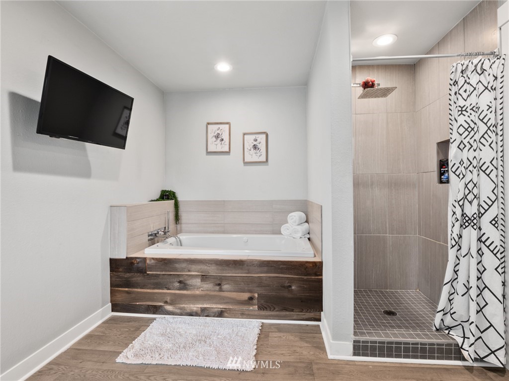 10222 Golden Given Road East Tacoma, WA 98445 - Photo 12 of 23 a bathroom with a bathtub and a shower
