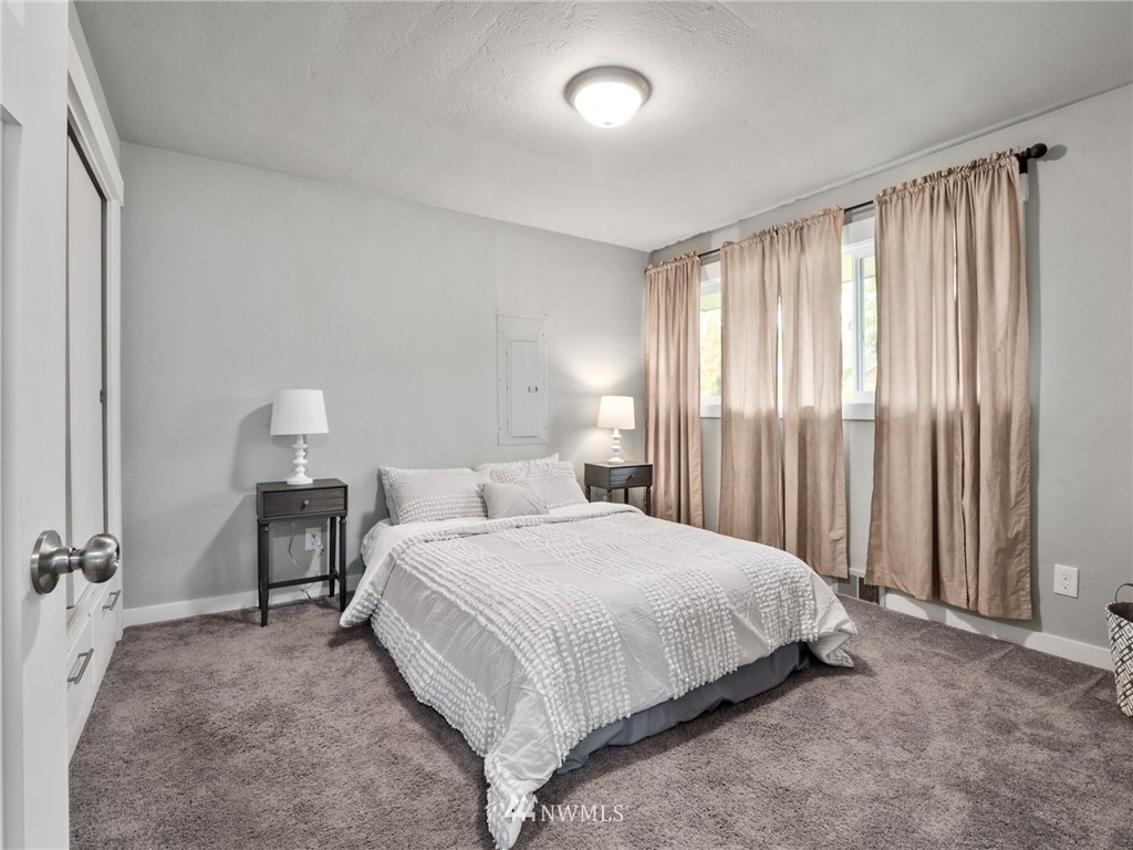 10222 Golden Given Road East Tacoma, WA 98445 - Photo 13 of 23 a bedroom with a bed and a table