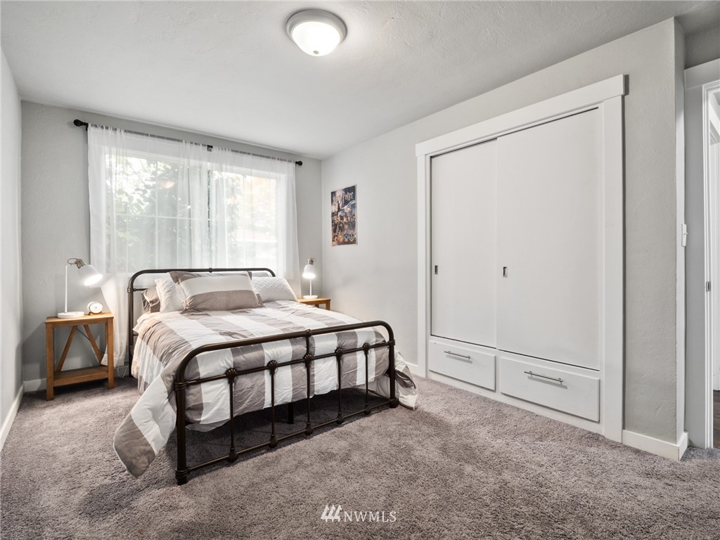 10222 Golden Given Road East Tacoma, WA 98445 - Photo 14 of 23 a spacious bedroom with a bed and a window