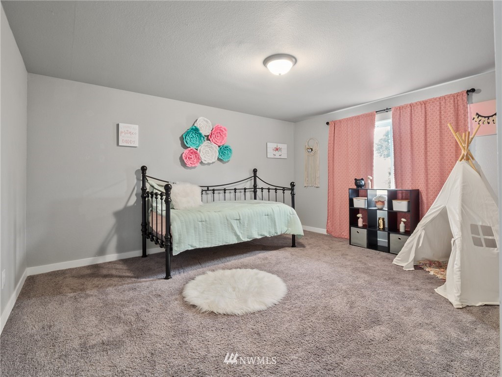 10222 Golden Given Road East Tacoma, WA 98445 - Photo 15 of 23 a bedroom with a bed and a window